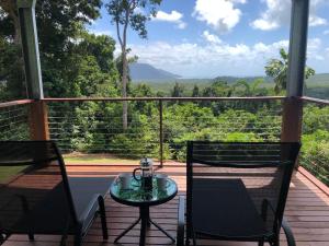 una mesa y 2 sillas en un porche con vistas en Daintree - House with a view, en Cow Bay