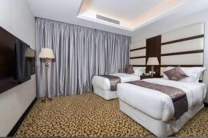 Postel nebo postele na pokoji v ubytování Verta Hotel Qouraish