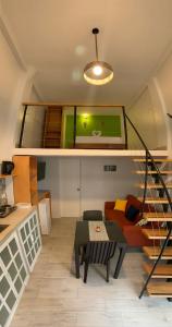 a living room with a table and a couch at La Quinta Loft Apartments in Iquitos