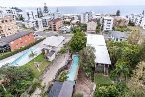 an aerial view of a house with a swimming pool at Kings Beach Coast and Glasshouse Views in Caloundra