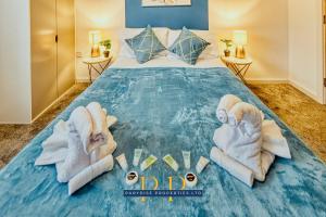 a bedroom with a bed with towels on it at The Sale Symphony Suite - By Parydise Properties - Business or Leisure Stays - Sleeps 6 - Sale, Manchester in Sale