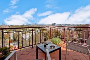 a balcony with a table and a view of the city at Expansive Views From Sydney 1 Bedroom Apartment in Sydney