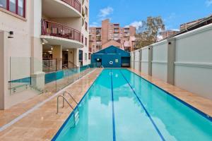 an empty swimming pool in an apartment building at Expansive Views From Sydney 1 Bedroom Apartment in Sydney