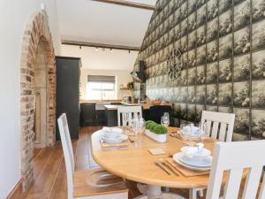 a dining room with a wooden table and chairs at Molly's Cottage in Malton