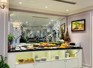 a display case with a bunch of food on display at Hotel du Monde in Hanoi