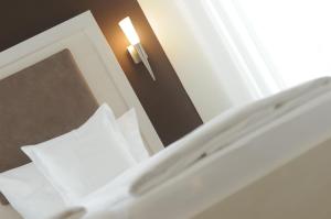 Postel nebo postele na pokoji v ubytování EWERTS Hotel