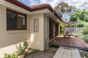 a small house with a wooden deck at 3 Bdrm 2 Bthrm House Close to Canberra CBD & ANU in Canberra