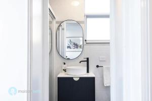 une salle de bain avec un lavabo et un miroir dans l'établissement Studio Apt With Parking Balcony & Water Views, à Sydney