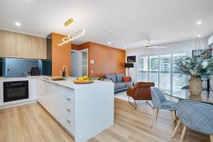 a kitchen and living room with a table and chairs at 1 Bedroom Gem with Aircon Stroll to Beach in Gold Coast