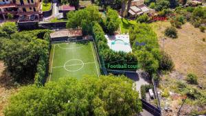 an aerial view of a tennis court with a soccer field at Ferienhaus für 11 Personen in Pedara, Sizilien Ostküste von Sizilien in Pedara