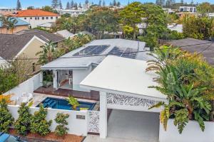 an aerial view of a house with a swimming pool at Gold Coast-Miami Mid-Century Beach Home With Pool in Gold Coast