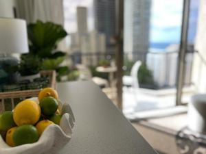 a bowl of fruit sitting on a table in a living room at Mantra View Studio Surfers Paradise Walk To Beach in Gold Coast