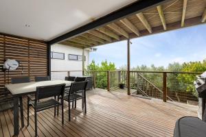 a balcony with a table and chairs on a deck at Port Views in Portarlington