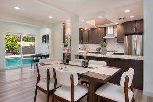 a kitchen and dining room with a table and chairs at Luxurious 4-Bedroom Home with Pool & Jacuzzi! in Los Angeles