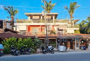 a group of motorcycles parked in front of a building at RedDoorz @ Hergem Siargao Inn in General Luna