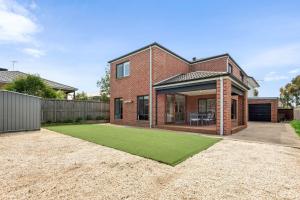 ein Backsteinhaus mit Rasen davor in der Unterkunft Getaway on the Rise in Portarlington