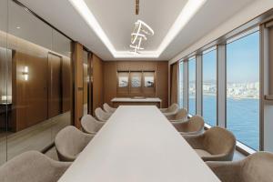 a long conference room with a long table and chairs at Wyndham Grand Busan in Busan