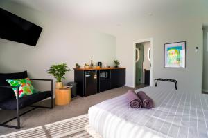 a bedroom with a bed with purple pillows on it at 239 High by Regional Escapes in Geelong