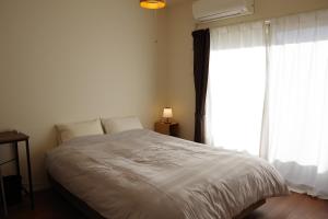 a bedroom with a bed with a large window at 笠岡　潮待ちHOTEL 