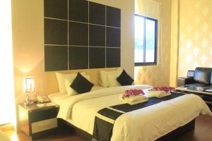 Letto o letti in una camera di Hotel Harmony In & Karaoke