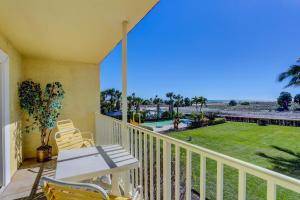 a balcony with a table and chairs and a view of a yard at South Beach Condo Hotel by Travel Resort Services, Inc. in St Pete Beach