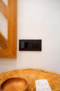 a outlet on a wall with a wicker basket at Bahandi Hotel in General Luna