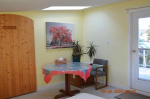 a table with a teddy bear on it in a room at Estuary House Reflexology B&B in Courtenay