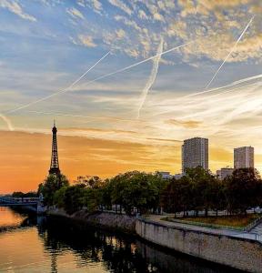 a view of a river with the eiffel tower at Loft 5 places with view on Eiffel Tower in Paris