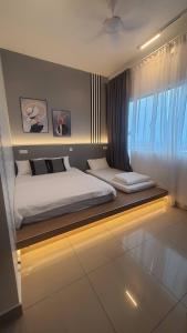 a bedroom with two beds and a window at Bear Paw Retreat Cityview Apartment Amber Cove in Melaka