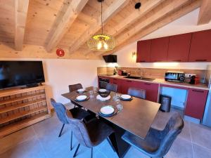 a kitchen with a table and chairs in a room at Appartement Les Gets, 3 pièces, 5 personnes - FR-1-598-162 in Les Gets