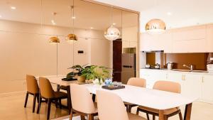 a kitchen and dining room with a white table and chairs at Hải Đăng Homestay - Hạ Long in Ha Long