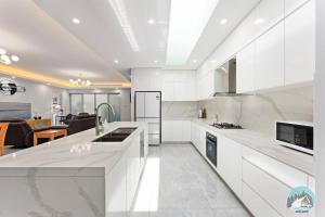a kitchen with white appliances and a living room at Aircabin - Fairfield - Modern - 6 Bedrooms House in Fairfield