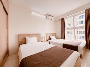a hotel room with two beds and a window at Hải Đăng Homestay - Hạ Long in Ha Long +85 photos