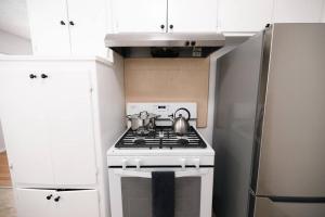 a kitchen with a stove and a refrigerator at ModernHaven -SoFi, Forum, Intuit in Hawthorne
