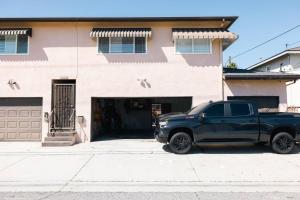 a black truck parked in front of a house at ModernHaven -SoFi, Forum, Intuit in Hawthorne
