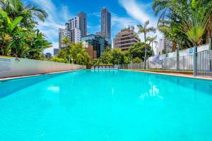 a large swimming pool with a city in the background at Condor Surfers - Hosted by Coastal Letting Company in Gold Coast