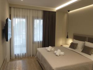 a bedroom with a large bed with two white pillows at MENTA in Litochoro