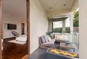 a living room with a couch and a fireplace at Spectacular Views: Exquisite Villa, Pool, Jacuzzi! in Los Angeles