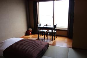 Postel nebo postele na pokoji v ubytování Hotel Shiosai