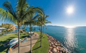 a view of the ocean from a resort with palm trees at Stunning 2BR Beachfront Retreat in North Ward