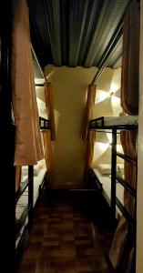 two bunk beds in a room with a hallway at TAGBALAYON Lodging House in Siquijor