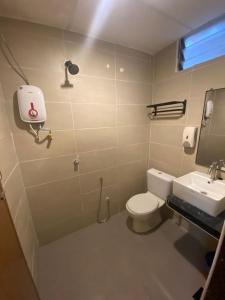 a bathroom with a toilet and a sink at Pangkor Bay View Beach Resort in Pangkor