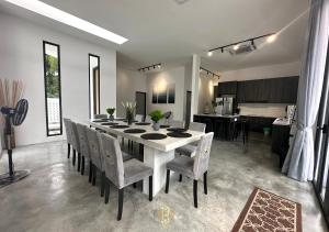 a dining room with a white table and chairs at The Luxurious 27, Johor Bahru in Johor Bahru