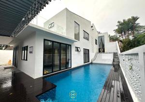 a house with a swimming pool in front of it at The Luxurious 27, Johor Bahru in Johor Bahru