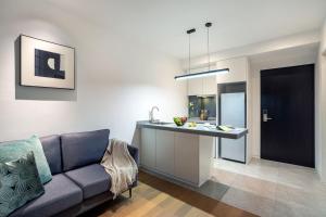 a living room with a couch and a kitchen at base-PUSAN Serviced Apartment in Shanghai