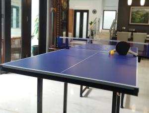 a ping pong table with a racket and a ball on it at Cottonwood Villa Mewah Nilaya @Dago - BBQ Pingpong in Bandung