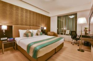 Postel nebo postele na pokoji v ubytování T24 Residency Mumbai International Airport Hotel
