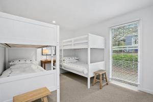 a bedroom with two bunk beds and a window at Evans Beach Retreat in Somers