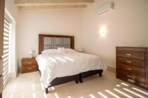 a bedroom with a large bed and two dressers at Villa Parvada in Parras de la Fuente