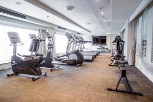 a gym with treadmills and ellipticals in a room at Apricot Hotel in Hanoi